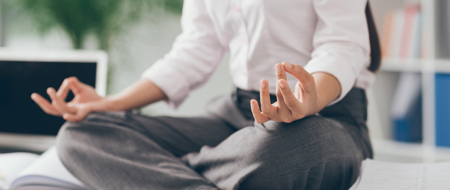 Business woman sitting in a lotus position