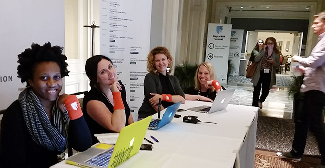 A few of the volunteers posing at the registration desk at the DPM Summit 2015