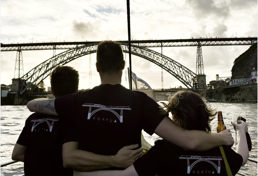 Members of the Resource Guru team wearing Porto-branded t-shirts at sunset.