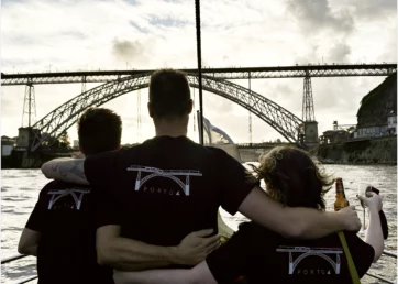 Members of the Resource Guru team wearing Porto-branded t-shirts at sunset.