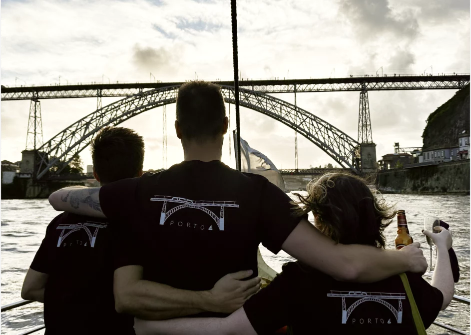 Members of the Resource Guru team wearing Porto-branded t-shirts at sunset.