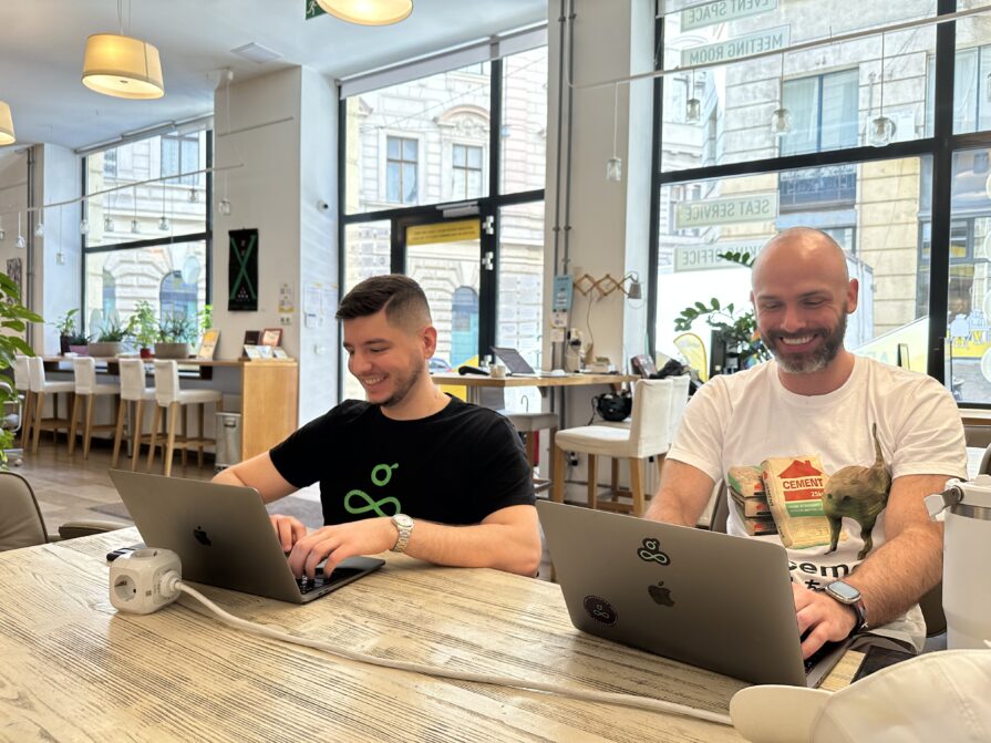 Resource Guru's Cristian and James working in Budapest on their laptops.