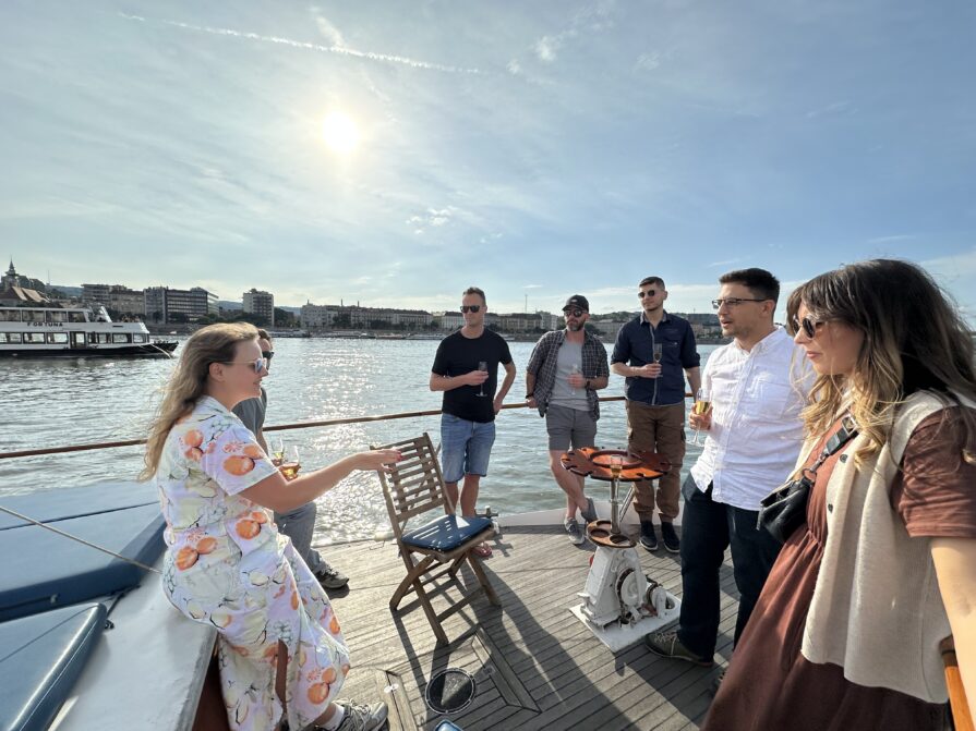 Dana from Resource Guru giving her team a tour from a boat on the Danube River in Budapest.